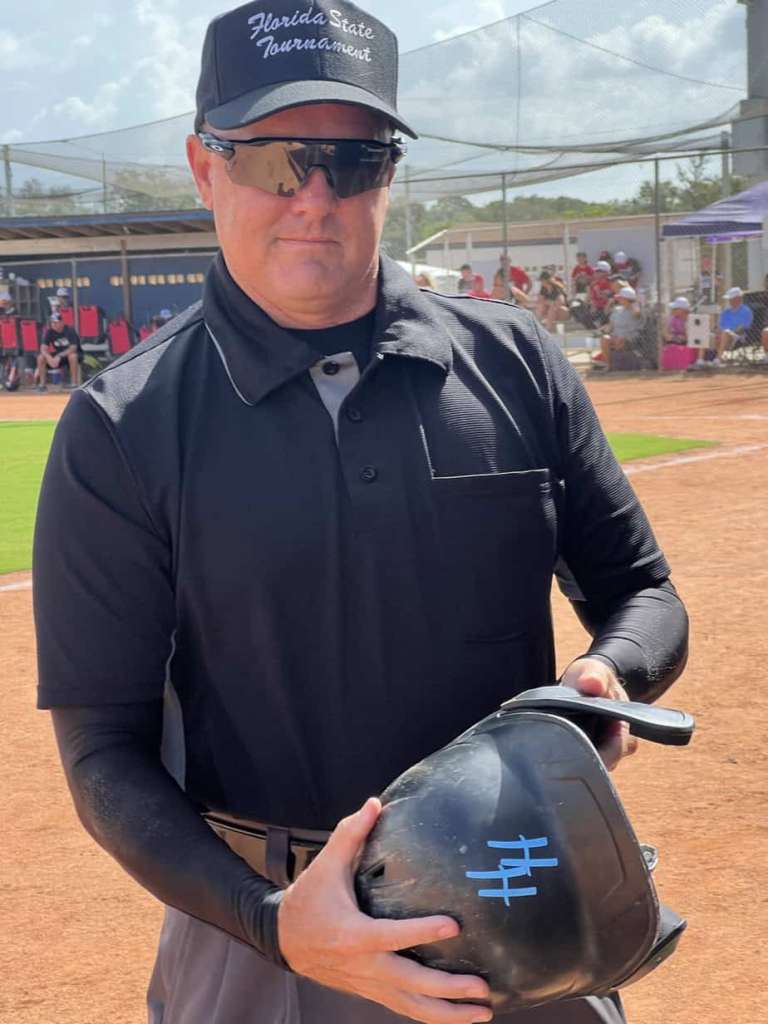 Tournament Umpire checking gear before a Little League game.
